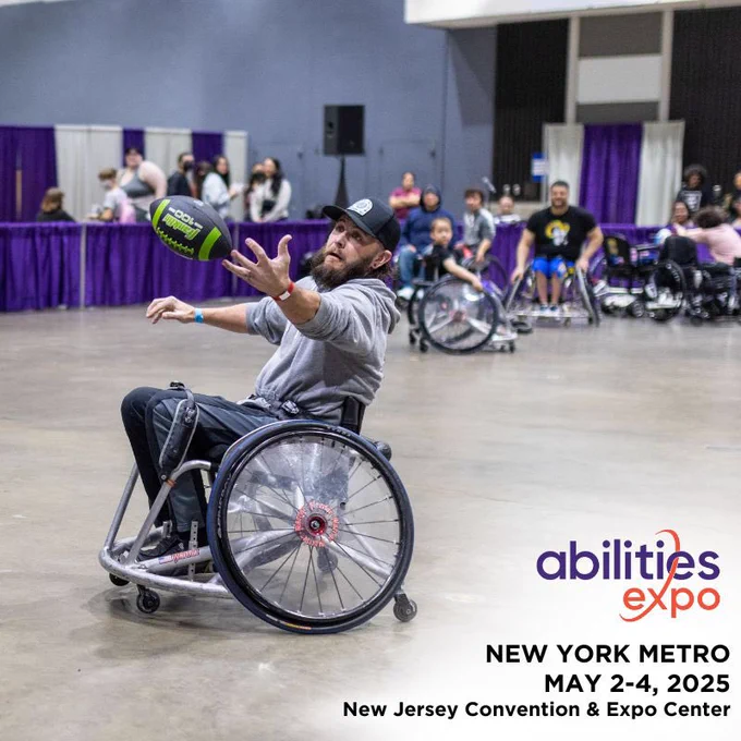 White male with black hat, grey hoodie, dark pants, and beard in wheelchair catching a football with hands outstretched. Background is faded and consists of other individuals watching the man catch the football. In the bottom righthand corner it reads: “Abilities Expo (logo).” In black writing: “New York Metro. May 2-4, 2025, New Jersey Convention & Expo Center.”