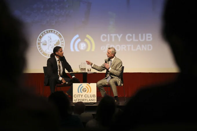 Mayor Wilson and JT Flowers sitting on the stage at Franklin High School having a conversation during the State of the City event, Mayor Wilson is looking at JT flowers and responding to question