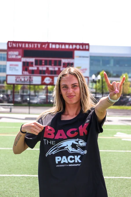 Alexa Versaci sports the Back the Pack shirt at Key Stadium with the scoreboard in the background.