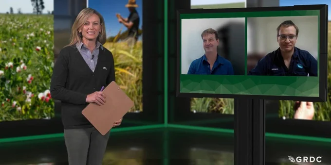Jane Foster in television studio setting stands in front of agricultural banners with two people appearing on a television screen beside her - Rick Llewellyn and Brendan Brown. 