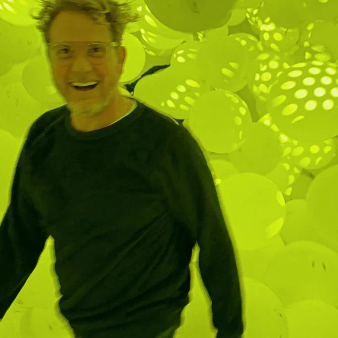 Brian Gattas Smiling in a pile of yellow balloons