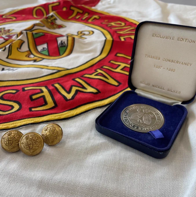 Three buttons, a coin, and a flag of the Thames Conservancy.