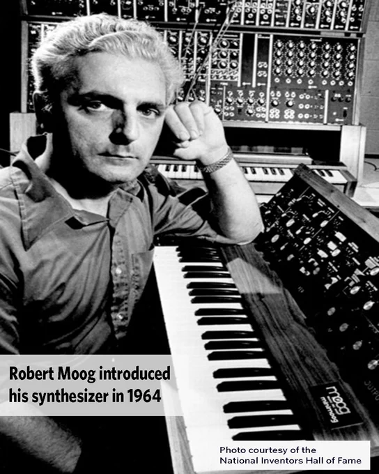 Robert Moog posing with his synthesizer, a complex electronic musical instrument with numerous knobs and cables, in 1964. Courtesy of the National Inventors Hall of Fame.