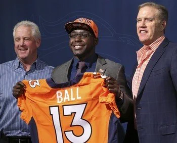 Montee Ball holds a Denver Broncos jersey after being selected with the 58th overall pick in 2013