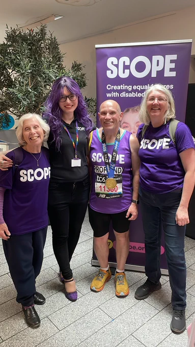 A Team Scope London Marathon finisher at the post-race reception with Scope staff.
