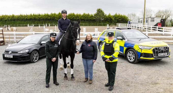 Police officers and horse rider standing beside a horse pictured alongside police cars.