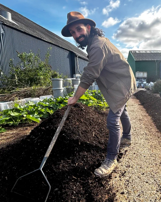 Michael Kennard raking up some of his compost