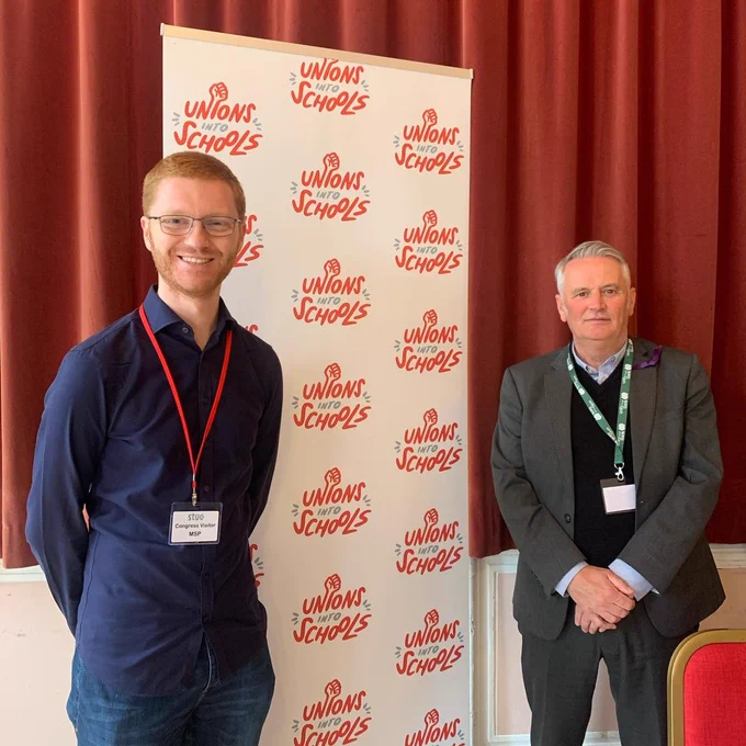 Ross & Terry in front of Unions Into Schools banner
