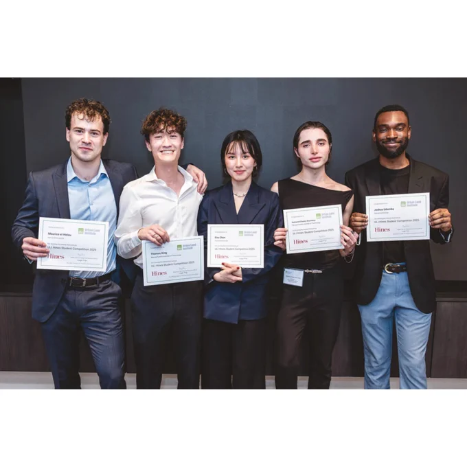 Five individuals stand in a row holding award certificates in front of themselves