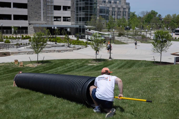 Photo of students and a tube.
