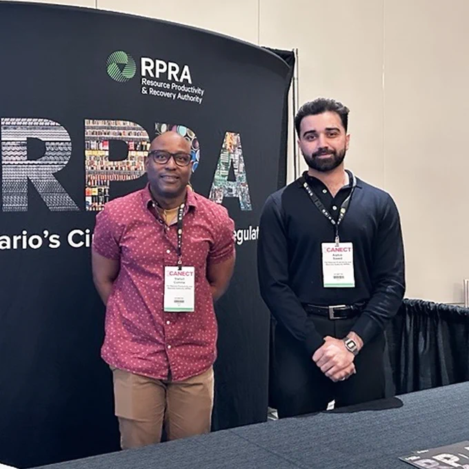 Two RPRA staff members at the CANECT’s Environmental Compliance and Due Diligence Training Event, standing at Booth #105. 