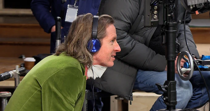 A behind the scenes photograph from The Wonderful Story Of Henry Sugar featuring Wes Anderson.