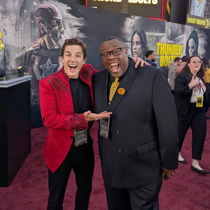 MatPat and Andre the Black Nerd on the red carpet of the Thunderbolts Premiere. They are both giving a classic wide mouthed YouTuber face.