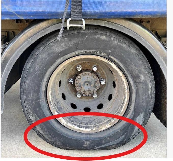 Tyre side view bulging with bearing the weight of the load.