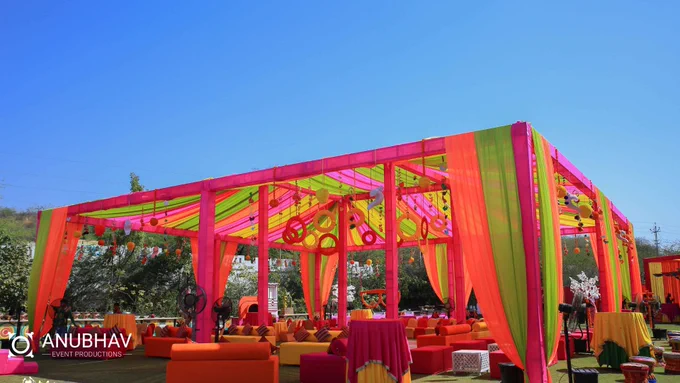 A vibrant gazebo tent adorned with colorful decorations at a mehndi event in Udaipur.