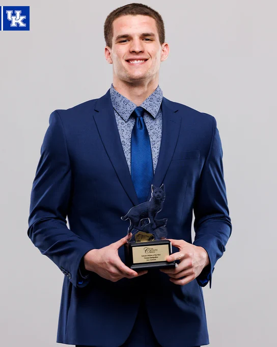 Grant Darbyshire holding his CATSPY award. 