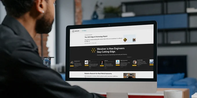 Image of man sitting at a computer; the screen is showing the Wevolver web page. 