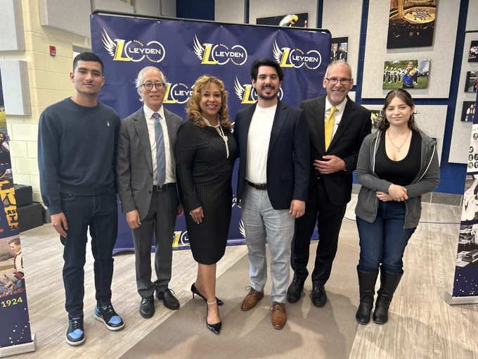 Victor Gomez (center) poses with former students and ISBE officials