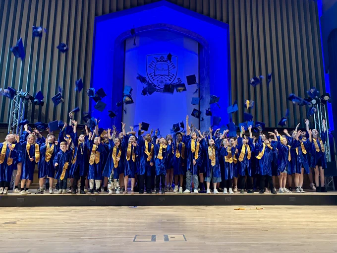 Children tossing their mortar boards in the air