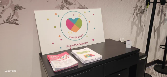 Social media board on a cabinet. It says I love peer support and features a love heart.
