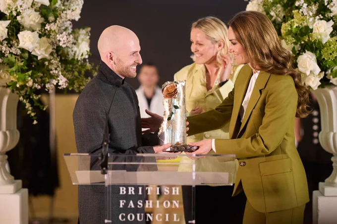 The Princess of Wales handing Patrick McDowell an award at a British Fashion Council event.