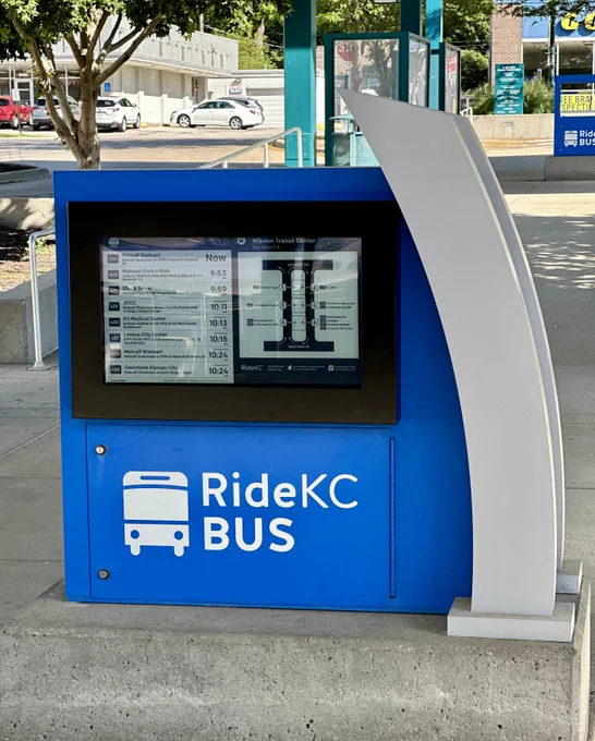 Final installed RideKC BUS kiosk at Mission Transit Center displaying a clean, working real-time screen with stop map and route arrival times.