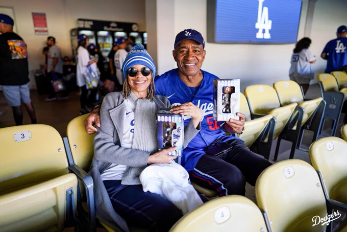 Dodger fans hold up their Mookie Betts bobbleheads.