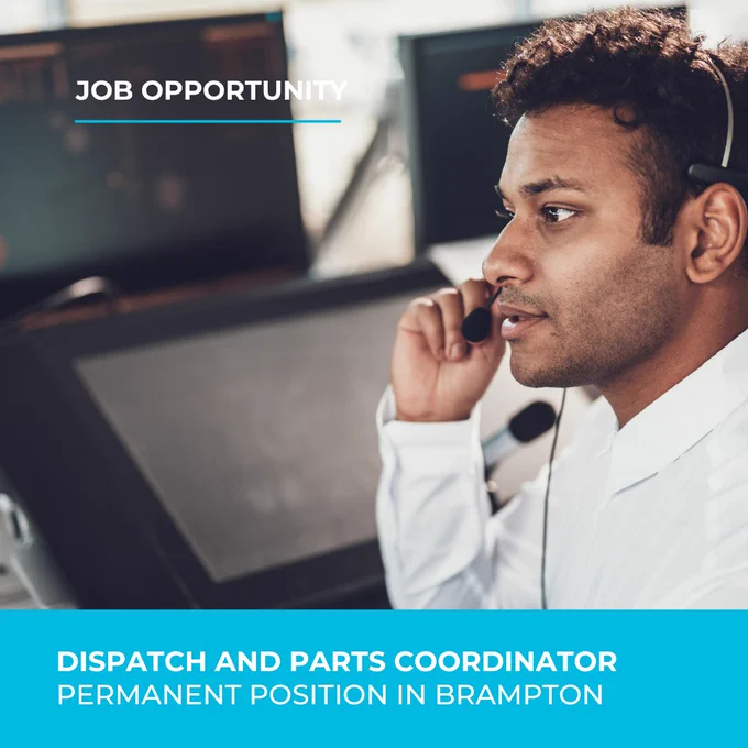 A man dressed business casual is speaking on the headset, the laptop monitor is in the background