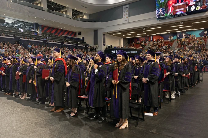 Kline School of Law Class of 2024 graduates stand at their seats in the UPMC Cooper Fieldhouse during their Commencement.