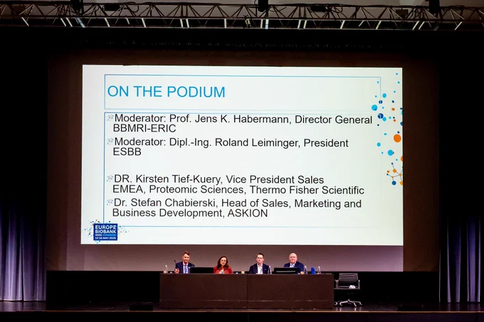 The picture of 4 people discussing on a stage