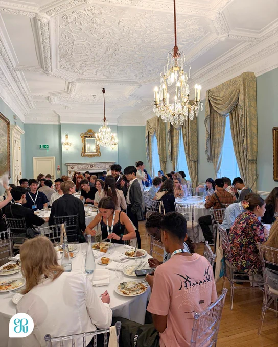 A photo of the International Public Speaking Competition participants eating dinner at Dartmouth House.