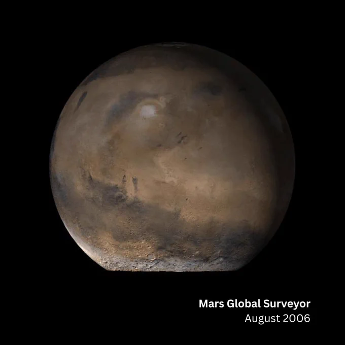 An image from August 2006 as taken by the Mars Global Surveyor spacecraft shows a mosaic of Mars. The bottom portion of the planet is cut off, but most of the globe is in tact. It's a reddish brown color with specks of gray along mountainous and valley areas. Along the bottom is text: "Mars Global Surveyor, August 2006" in white lettering.