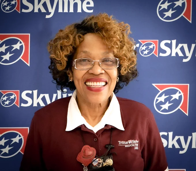 HCA Healthcare colleague Faye Duke smiling in front of a TriStar Skyline backdrop