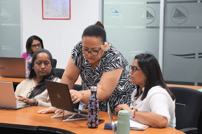 Doreen Tuala of SPC co-facilitating the training workshop for the Assessment Instrument Development Micro-Qualification. She is assisting two participants with their assessment tasks.