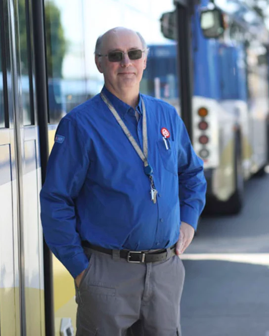 Photo of Joe Wiggins wearing a blue long sleeve trimet work shirt