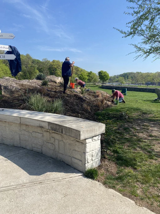 Three men on a hill weeding