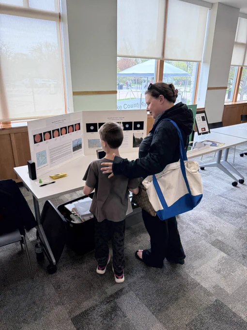 Families enjoying Astronomy Day displays