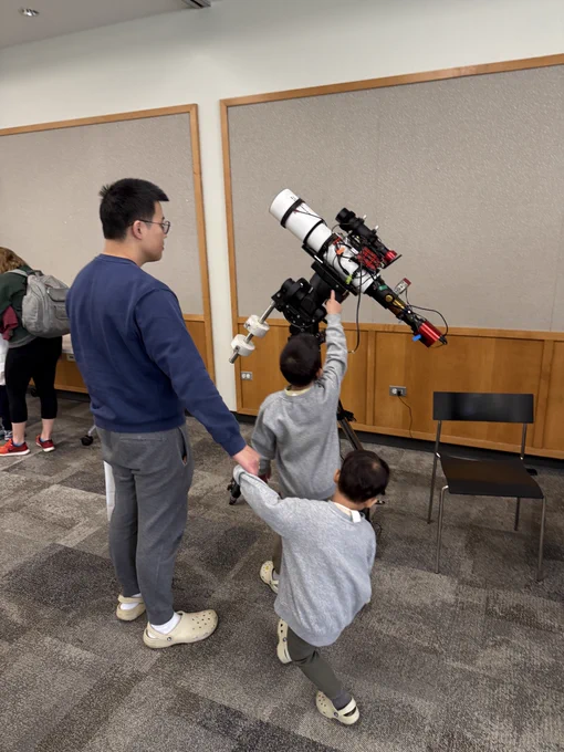 Young children checking out the telescope