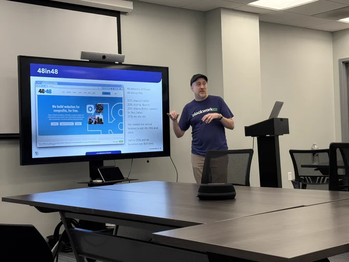 Aaron Riemann in front of a screen showing the 48in48 website as he talks about Cloudflare