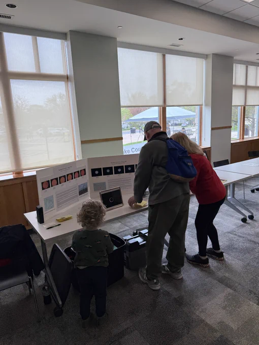 A family looking at an Astronomy display