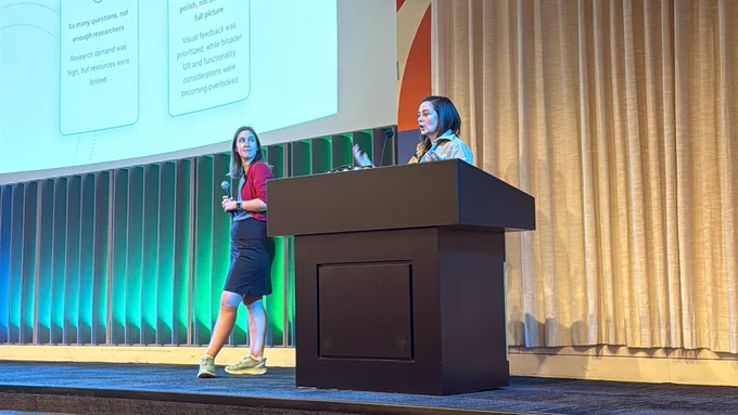 Natalie and Rebecca on stage at ColorCode talking about heuristics in web design.