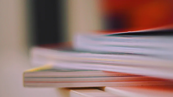 blurry photo of books; no titles visible
