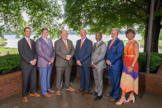 A group of people posing for a photo outdoors.