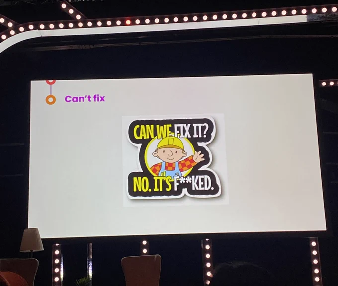 A presentation slide features a humorous sticker with the character Bob the builder. The text reads: "CAN WE FIX IT? NO. IT'S F**KED."