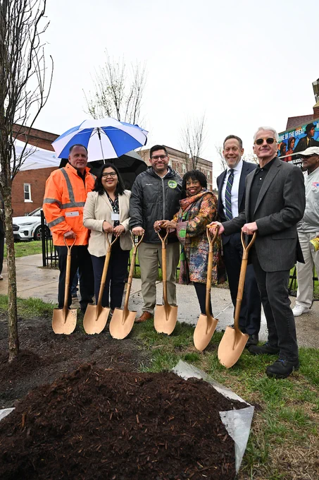 Group of six individuals, including City of Chicago staff, participating in a ceremonial tree-planting event hosted by Blacks In Green on Arbor Day.