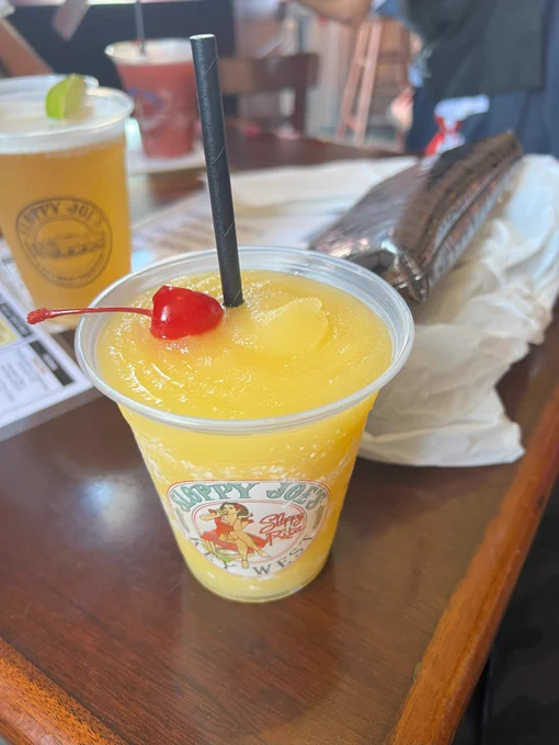 That moment when Key West hits different... 😎

Listen.

Some people write poetry about sunsets.
Some paint pictures of palm trees.

But THIS right here?

This frozen moment of paradise with a cherry on top...

Is pure Keys art.

That perfect yellow swirl...
That little red cherry playing lifeguard...
That Sloppy Joe's cup telling stories without saying a word...

It's not just a Rum Runner.

It's literally happiness in frozen form.

And yeah, maybe it's barely afternoon.

But you're in Key West.

Where the only rule about frozen drinks is:
"If you can see it, you can sip it."

#KeyWest #IslandLife #RumLife #ParadiseFound #KeysBeingKeys

(Just a heads up - there's another beer chillin' in the background looking mighty fine too... decisions, decisions... 😏)