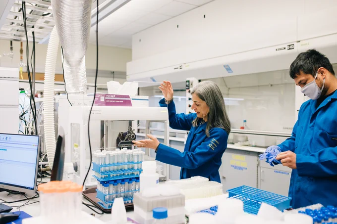 A photo of Sabeeha Merchant in a lab environment at a piece of equipment. Photo by Anastasiia Sapon