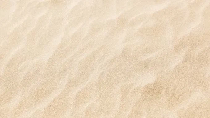 A field of sand with granular ripples in it.