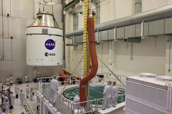 Crews use a massive crane to lift NASA’s Artemis II Orion spacecraft onto the agency’s KAMAG transporter inside the Neil A. Armstrong Operations and Checkout Building at Kennedy Space Center in Florida on Thursday, May 1, 2025. Credit: NASA/Frank Michaux