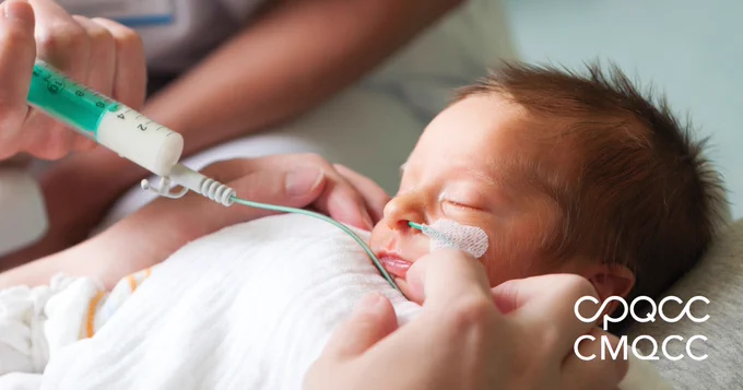 A baby in the neonatal ICU is fed through a special feeder.